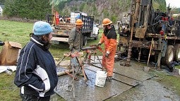 Jill Marshall watches as workers operate drilling equipment