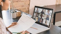 Woman in Zoom meeting on laptop