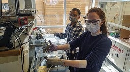 Students working on an electrolyzer in lab
