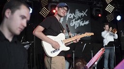 Band member playing guitar