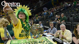 Victoria Williams '81 the bingo wheel, picking out a winner. Courtside announcer Don Essig '64, '71, to the right, calls out the numbers. Photograph by John Bauguess