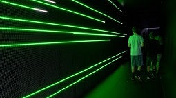Students next to green neon lights