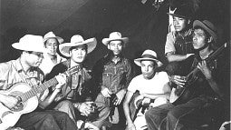 Workers playing guitars. 