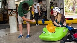 Getting outfitted for a kayak trip at the Outdoor Program Barn