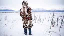 Person standing in snow with back to camera