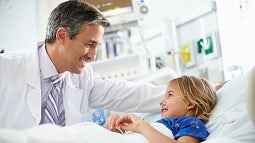 Doctor treating child in hospital