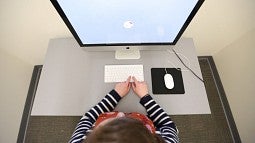 Overhead view of a person in front of a computer screen