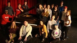 Choir students around piano