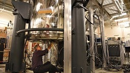 Researcher Karl Mueller working on lab equipment at the PNNL