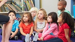 Presschool children listen to their teacher