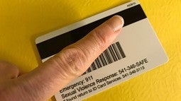 The back of a new ID card with finger pointing to proximity number