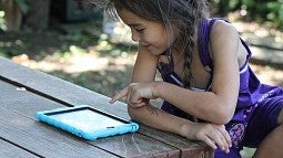 Child working on computer tablet