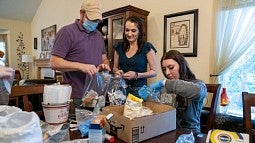 Shawna Heurgue with family making kits for the homeless