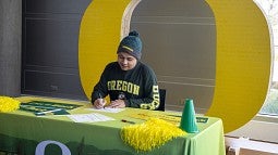 Student signing enrollment form