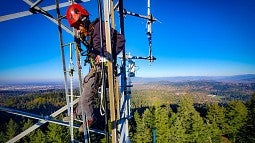 Climber on communications tower