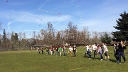 Students launch the atlatls they built