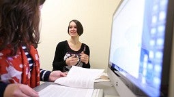 Students using paper and digital study materials