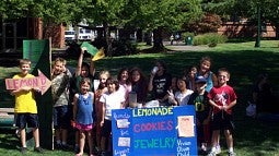 Children selling lemonade on campus