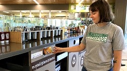 Sustainability Ambassador at recycling bin