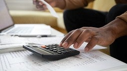 Person working on calculator