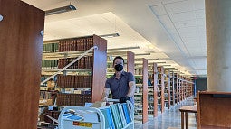 Librarian moving books