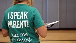 A staff member at IntroDUCKtion wearing a shirt reading I Speak Parent