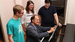 Robert Kyr (seated) with three students