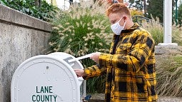 Student putting ballot in ballot box