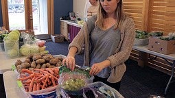 Kiara Kashuba preparing food with Cornerstone Community Housing in partnership with Food for Lane County at Willamette Gardens 