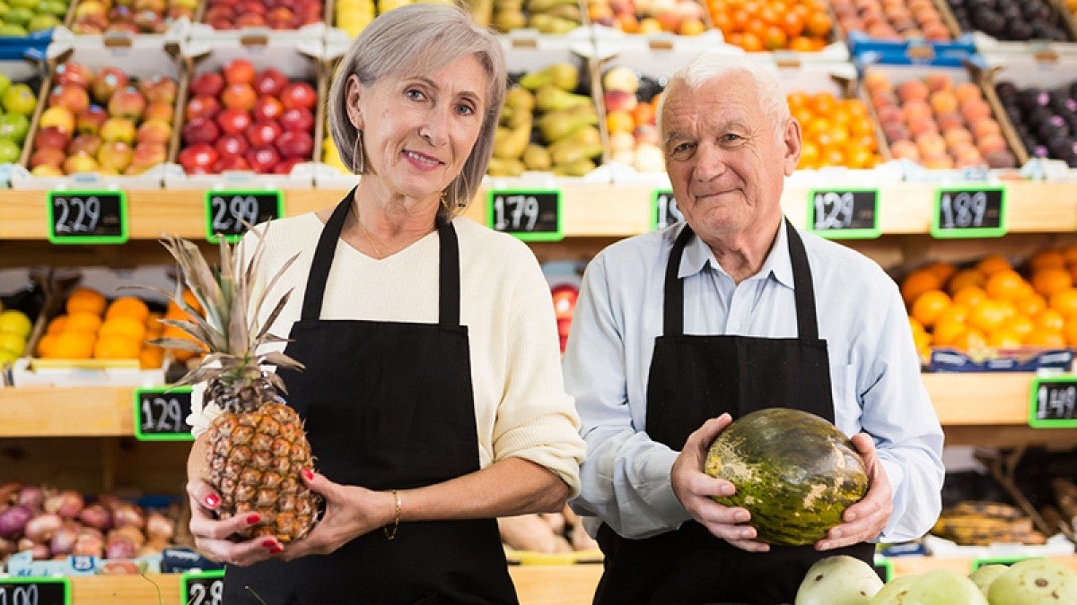 Two older grocery store workers