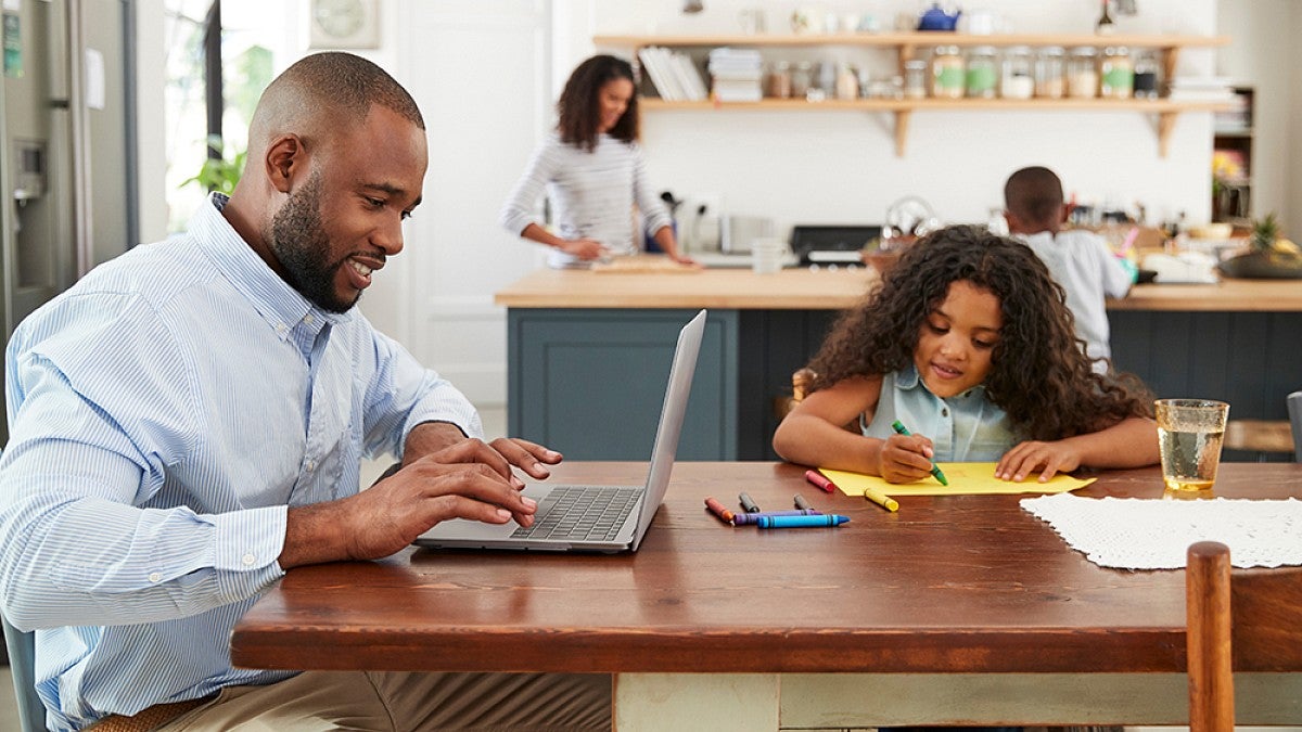 Parent working at dinner table