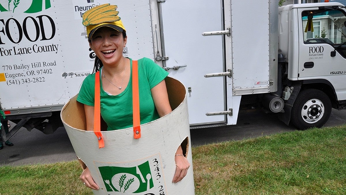 A woman wears a Food for Lane County barrel