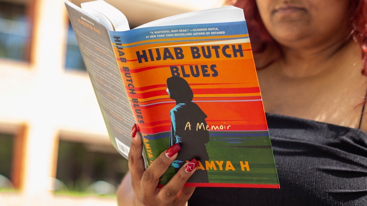 Woman reading Hijab Butch Blues hardback book