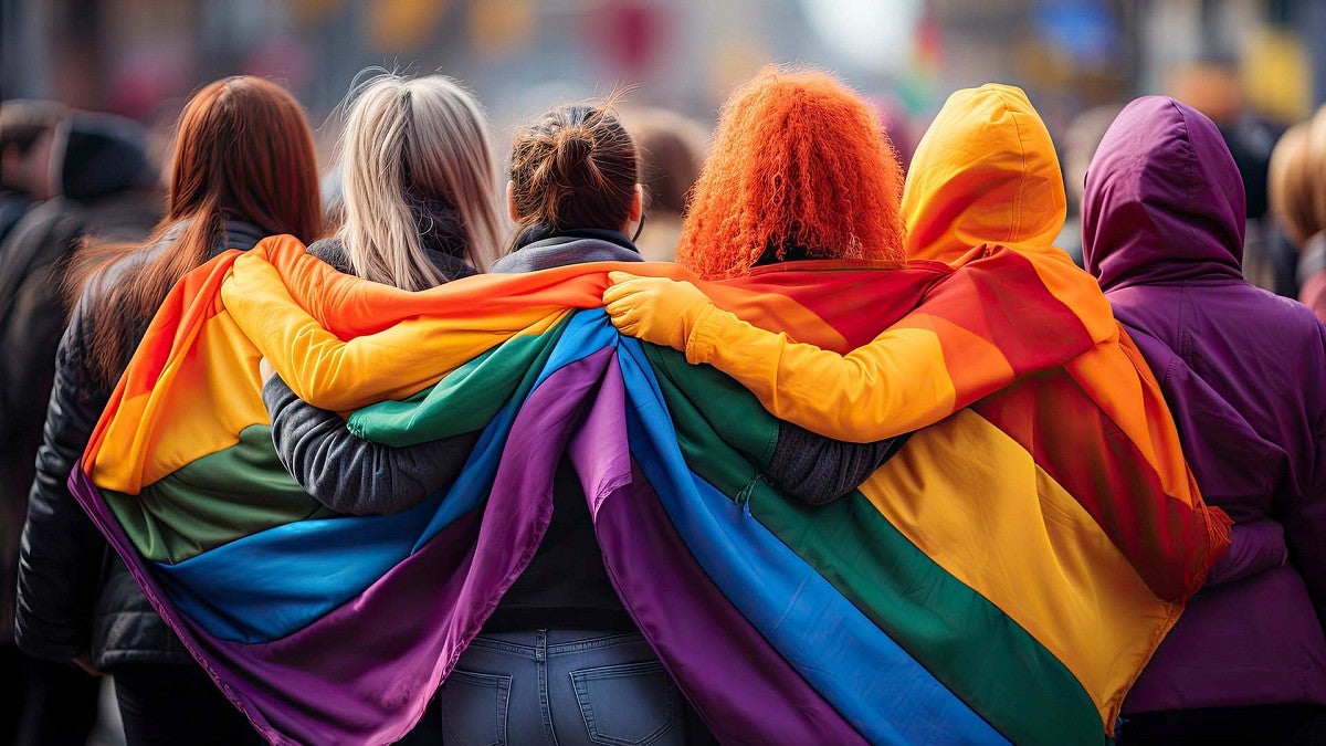 Students draped in rainbow flag