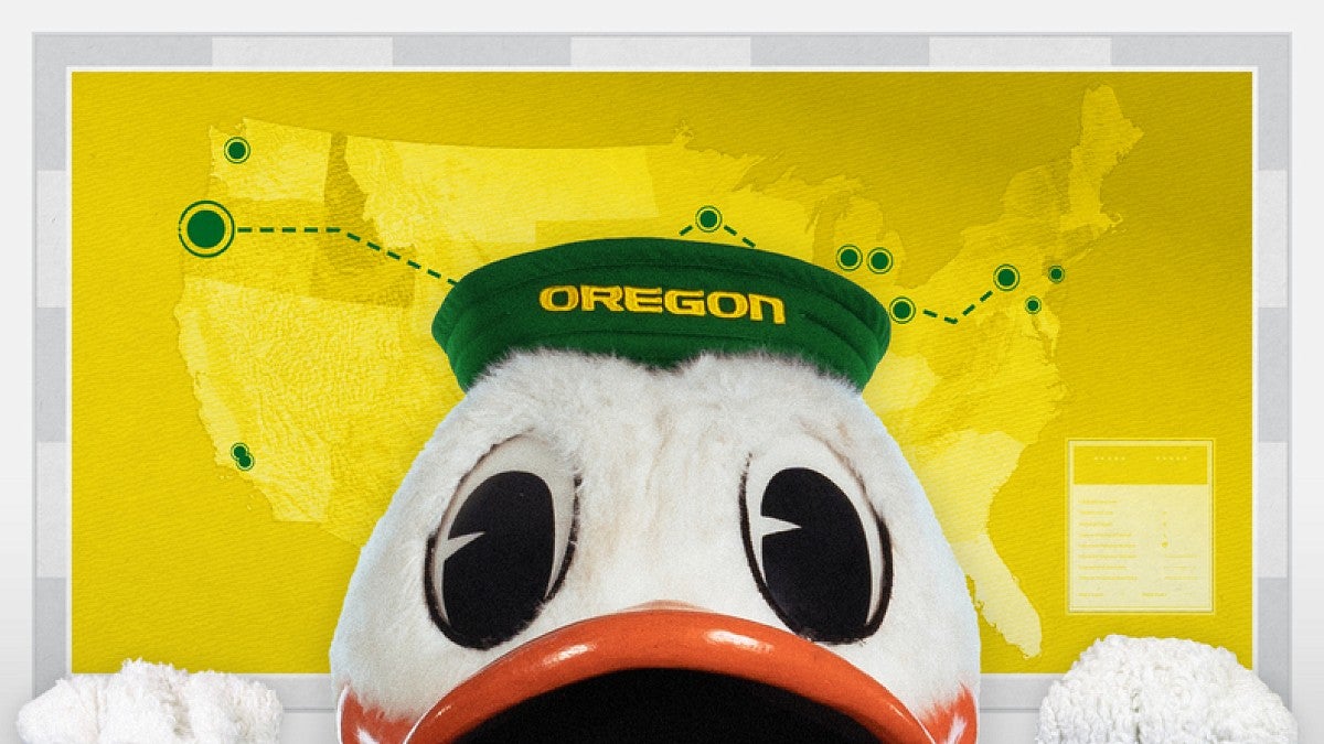 The duck peeking over and edge with a map of Big Ten school locations in the background