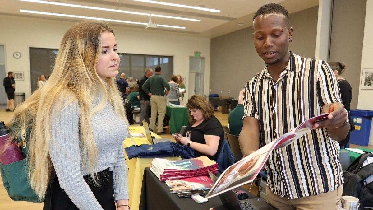 two people read a benefits brochure