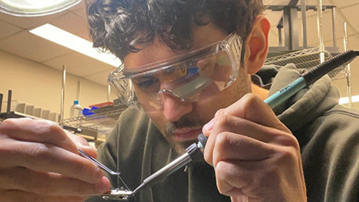 Wearing safety glasses, Matthias De Kok handles instruments in the SHARP Lab.