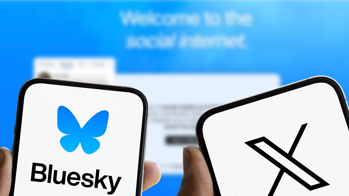 Two cellphones, one showing a Bluesky logo and the other an X logo