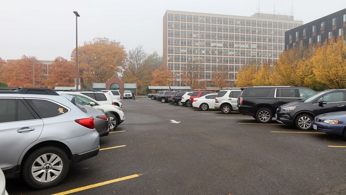 cars in parking lot at University of Oregon with Prince Lucien Campbell Hall in background