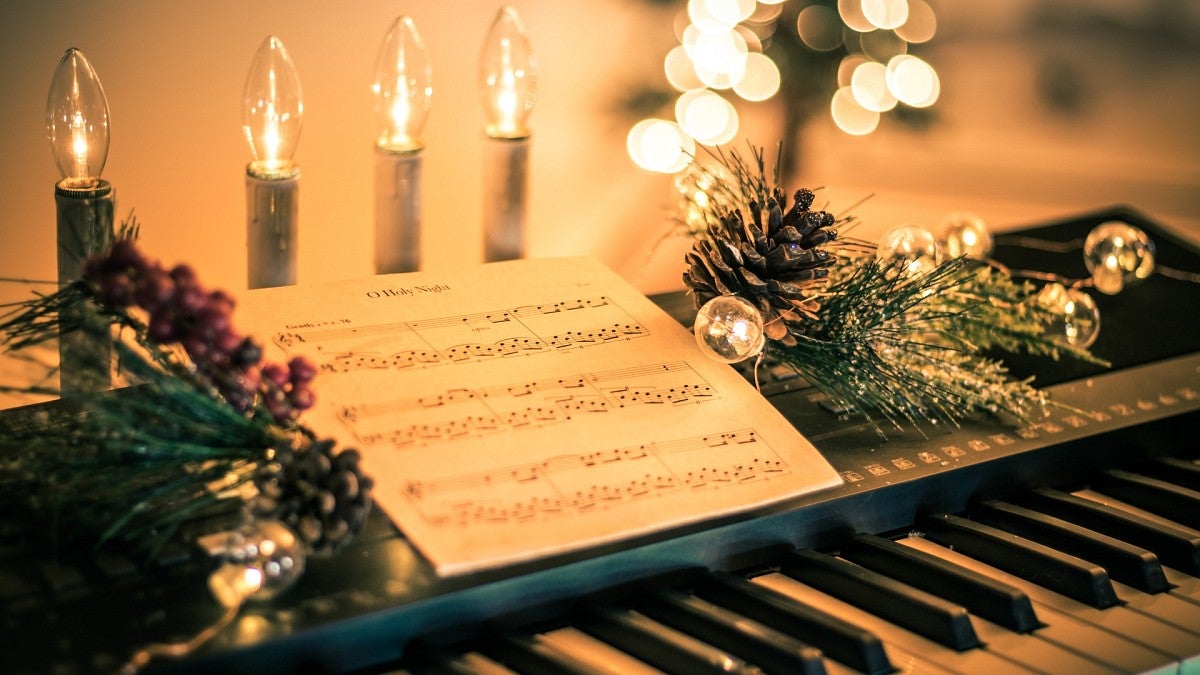 Christmas music at piano decorated for the holiday