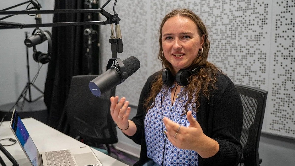 Erin Morrison in a studio recording a podcast