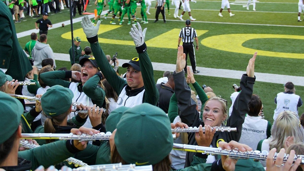 Anna Frazer raises hands in front of the band