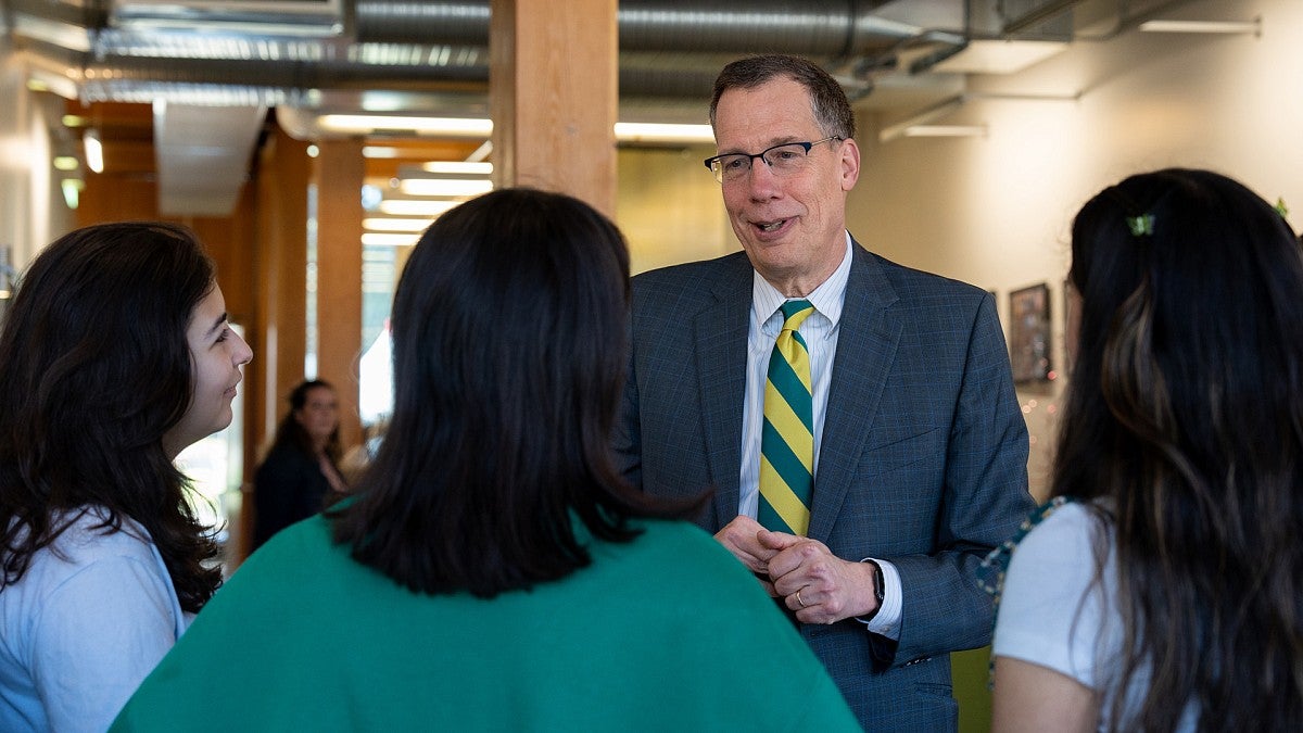 UO President Karl Scholz talking with students