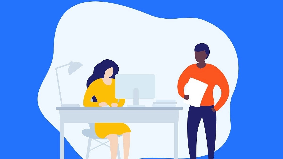 two people at a desk in an office