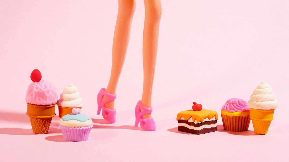 Toy candies next to a doll's legs