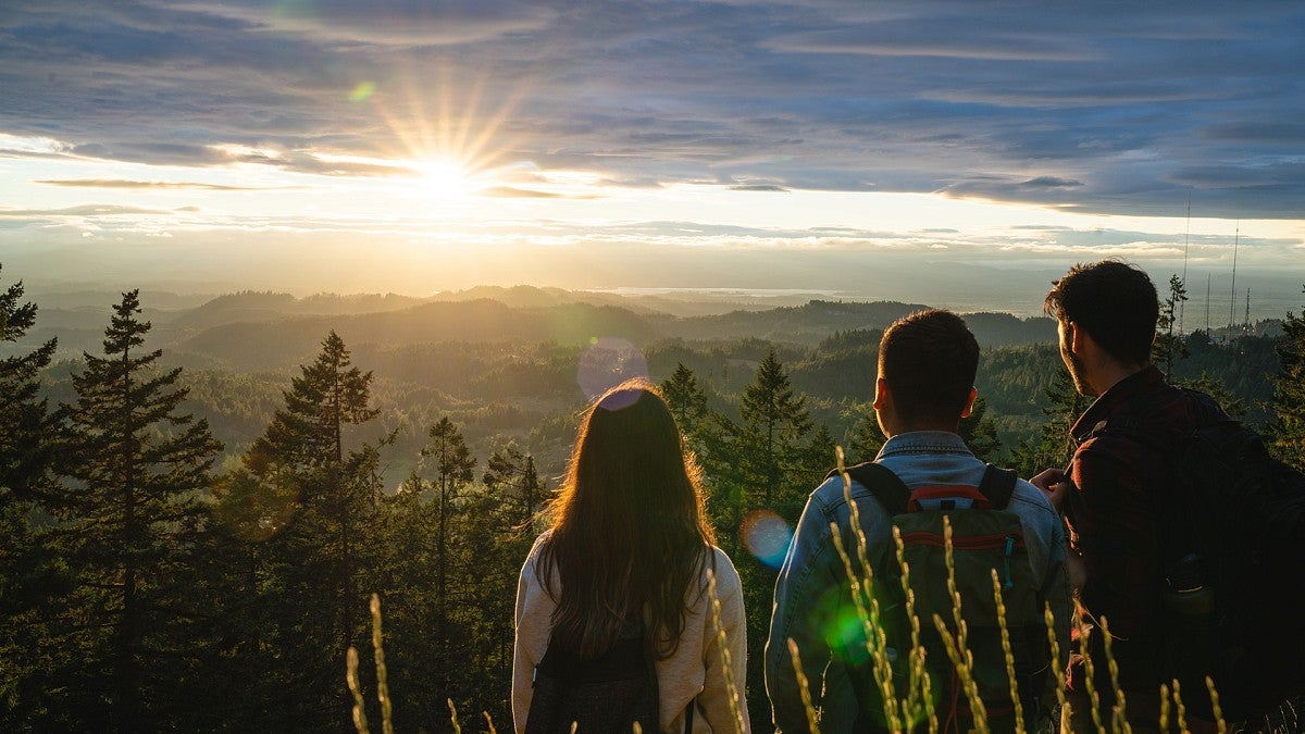 Students watching sunset from the top of Spencer Butte