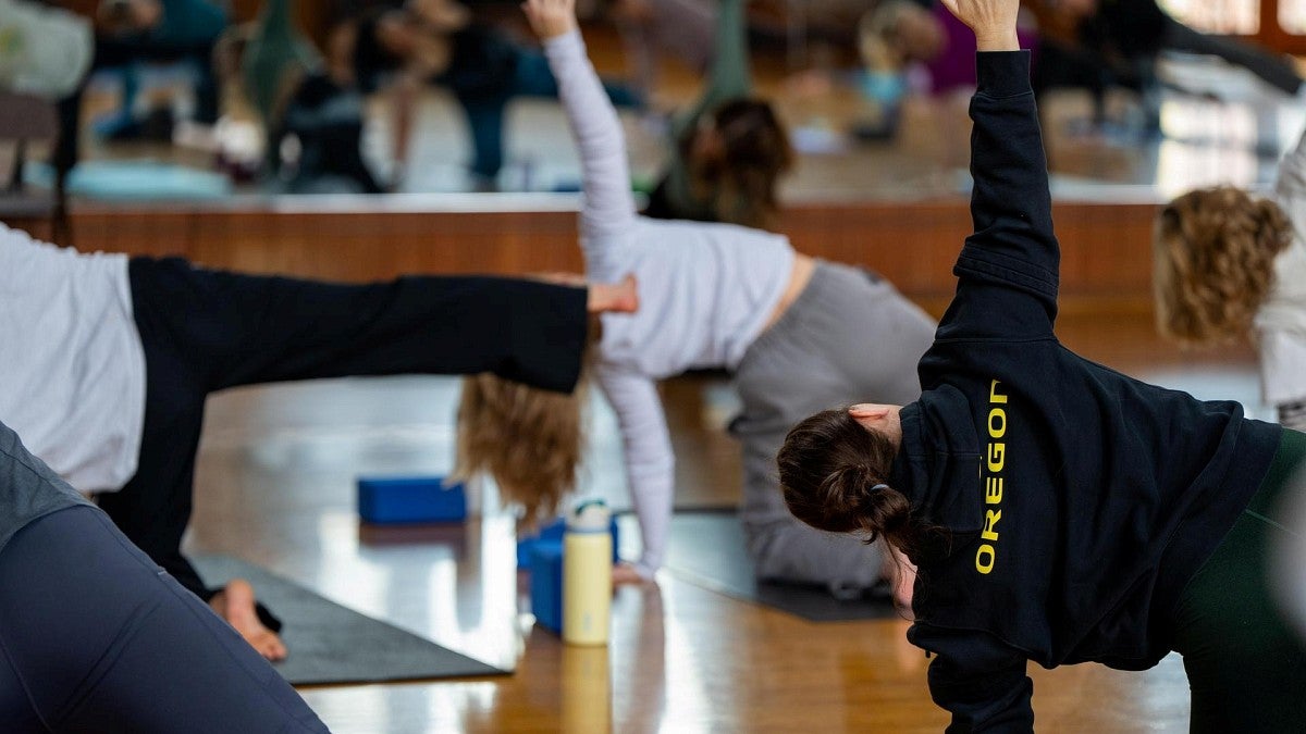 employees performing yoga exercises