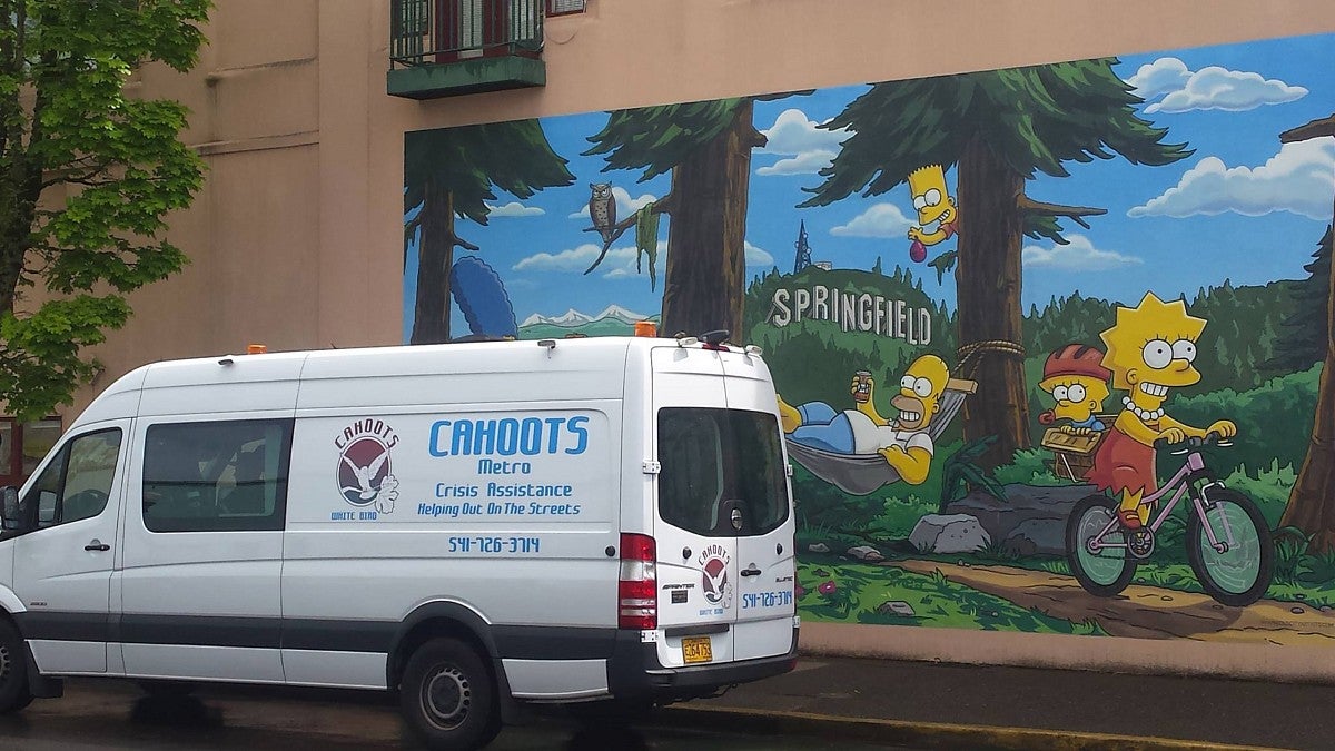 The CAHOOTS van parked in front of a mural of The Simpsons in Springfield