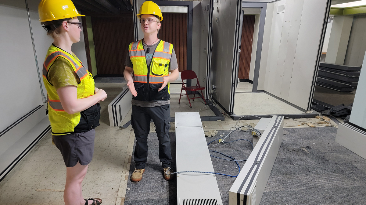 Lillian Moses and Andrew Schumacher, of Housing Capital Construction, are managing reusable and recyclable Hamilton Hall assets including these modular acoustic rooms that will go to other UO units (photo: Matt Cooper, University Communications)