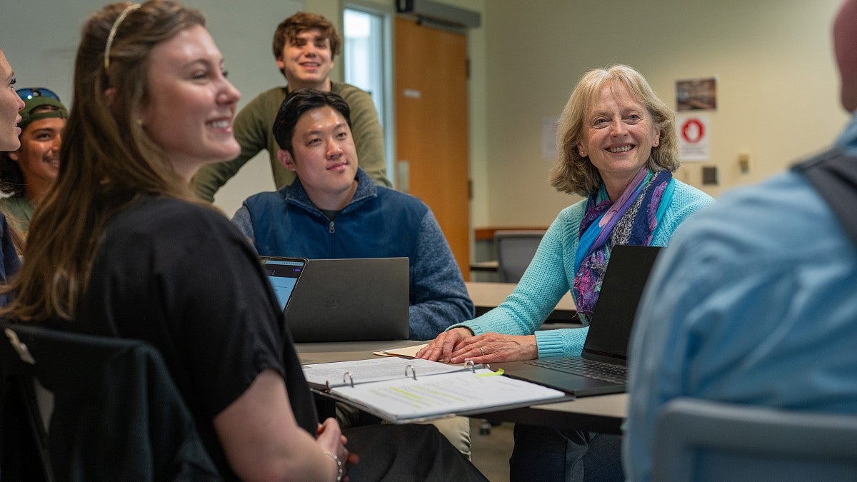 Suzanne Rowe talking with a group of students